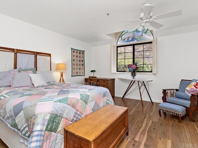 bedroom with ceiling fan and hardwood / wood-style flooring