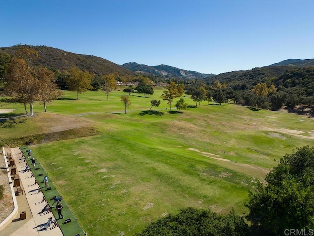 view of home's community with a mountain view and a lawn