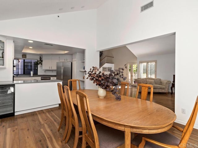 dining area featuring wine cooler and dark hardwood / wood-style flooring