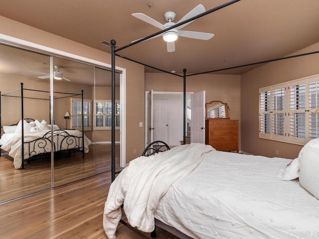 bedroom with wood-type flooring, a closet, and ceiling fan