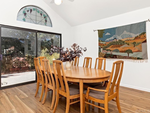 dining area with light hardwood / wood-style floors, high vaulted ceiling, and ceiling fan