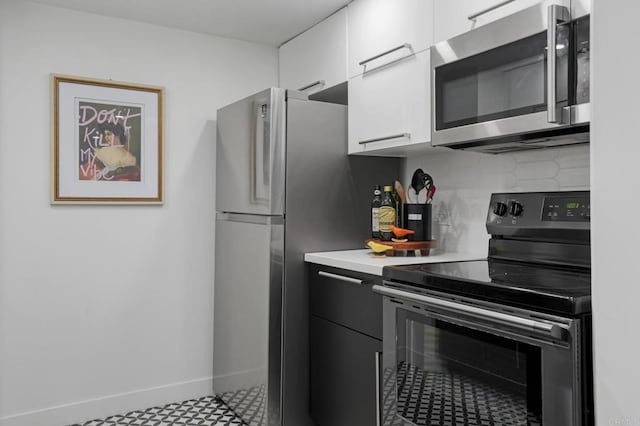 kitchen featuring backsplash, white cabinets, and stainless steel appliances