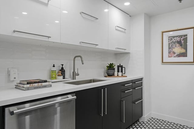 kitchen with tasteful backsplash, dishwasher, sink, and white cabinets