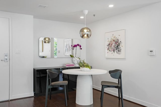 dining space featuring breakfast area and dark wood-type flooring