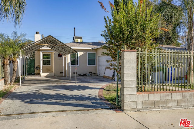 view of front of house with a carport and a garage