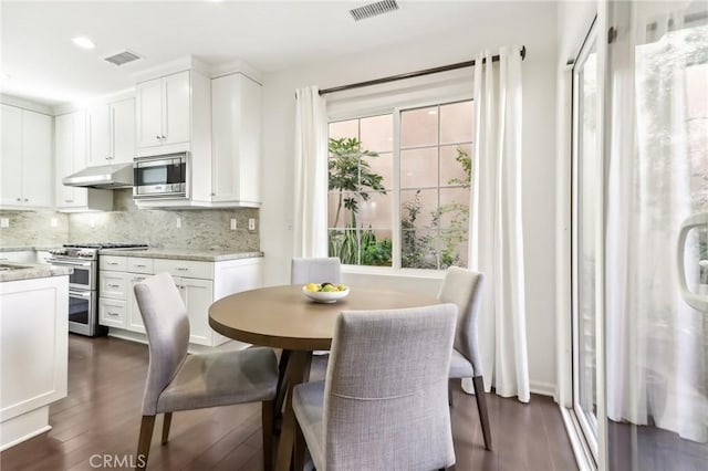 dining space featuring dark hardwood / wood-style floors