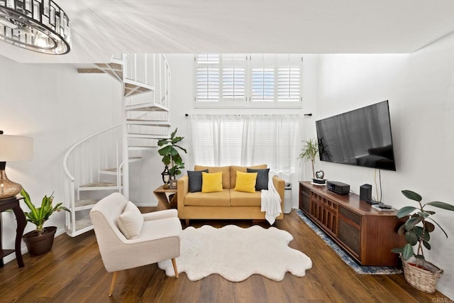 living room featuring dark hardwood / wood-style flooring and a towering ceiling