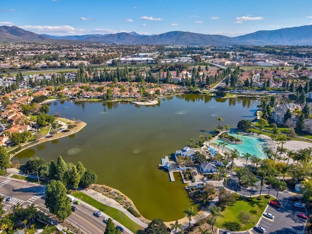 drone / aerial view featuring a water and mountain view