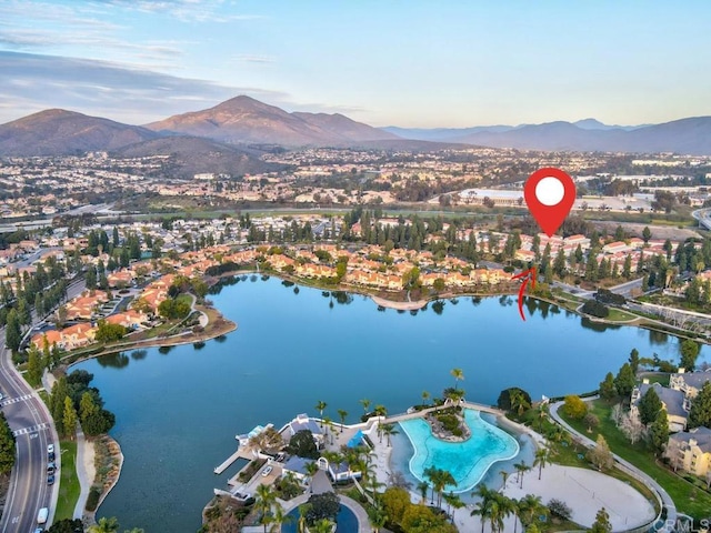 drone / aerial view featuring a water and mountain view