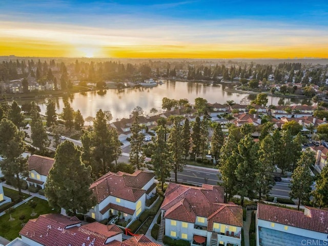 aerial view at dusk with a water view