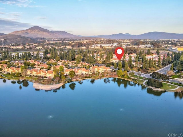 birds eye view of property with a water and mountain view