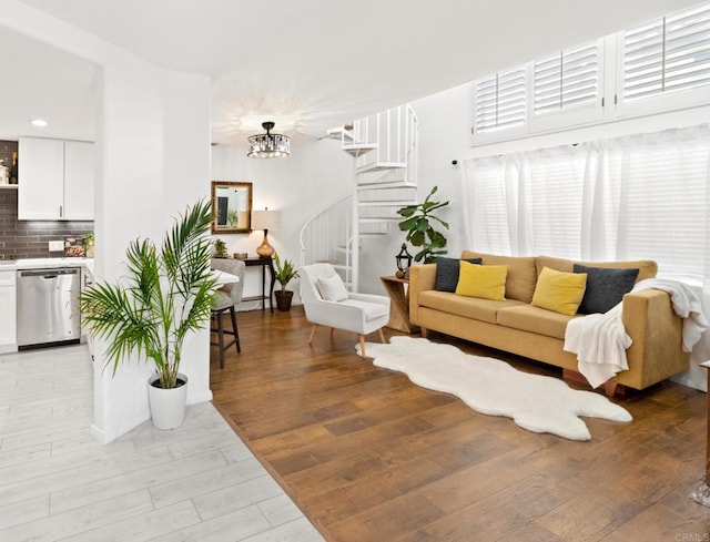 living room with a chandelier and light hardwood / wood-style flooring