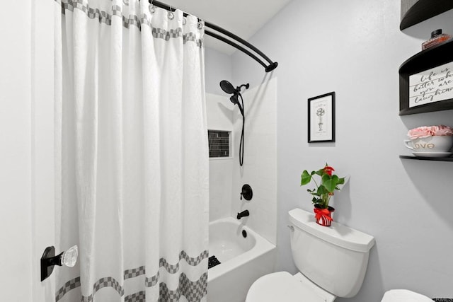 bathroom featuring shower / bath combination with curtain and toilet