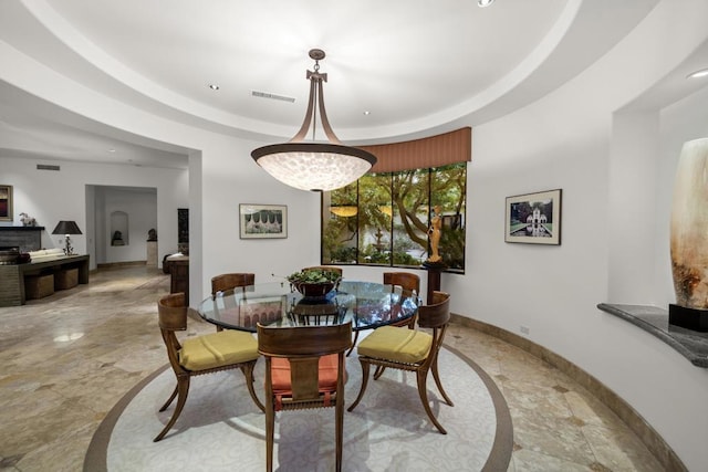 dining space with a raised ceiling