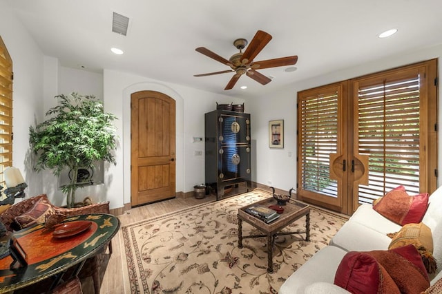 living room with ceiling fan, french doors, and light hardwood / wood-style floors