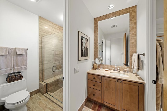 bathroom with vanity, toilet, and walk in shower