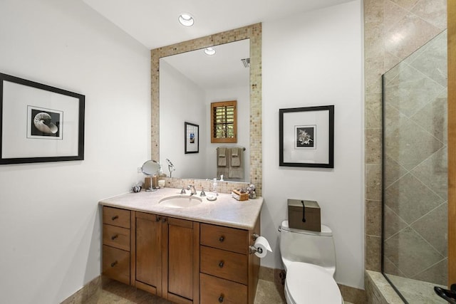 bathroom featuring tiled shower, vanity, and toilet