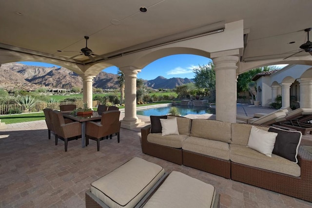 view of patio / terrace featuring a mountain view, an outdoor living space, and ceiling fan