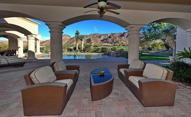 view of patio / terrace with a mountain view and ceiling fan