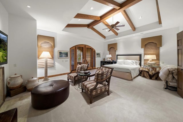 carpeted bedroom with beamed ceiling, ceiling fan, and high vaulted ceiling