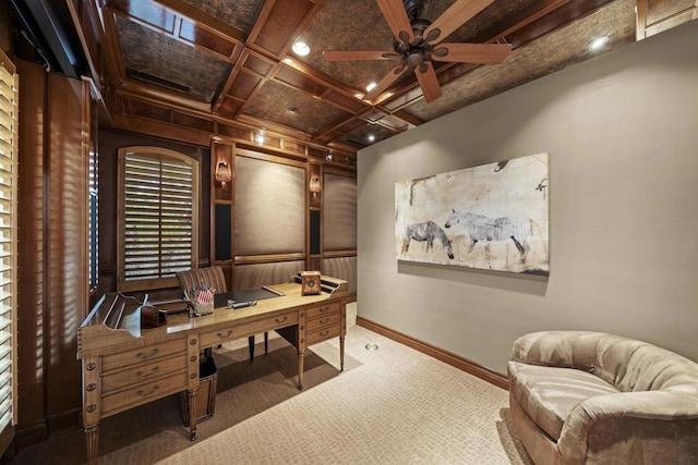 carpeted home office featuring beamed ceiling, ceiling fan, and coffered ceiling