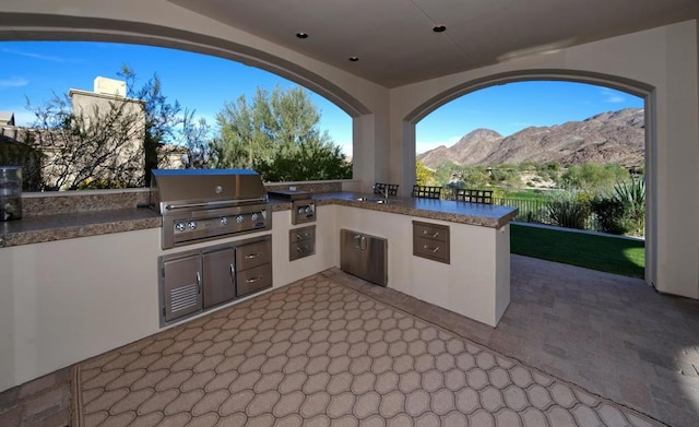 view of patio / terrace with a mountain view and area for grilling