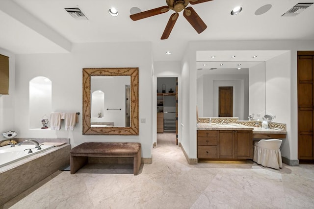 bathroom with vanity, ceiling fan, and tiled tub