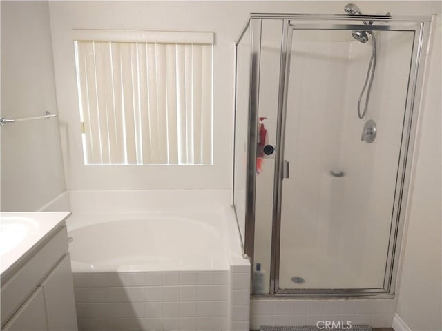 bathroom featuring vanity and plus walk in shower