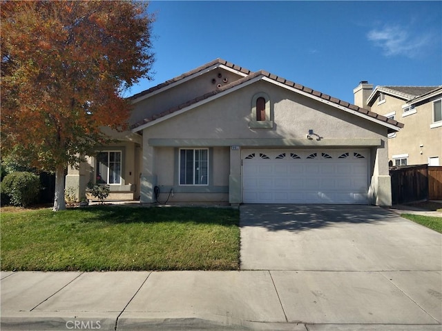 view of front of home featuring a garage and a front lawn