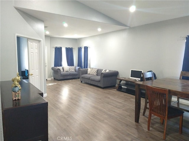 living room featuring hardwood / wood-style flooring and lofted ceiling