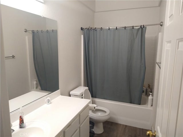 full bathroom with shower / tub combo with curtain, vanity, wood-type flooring, and toilet