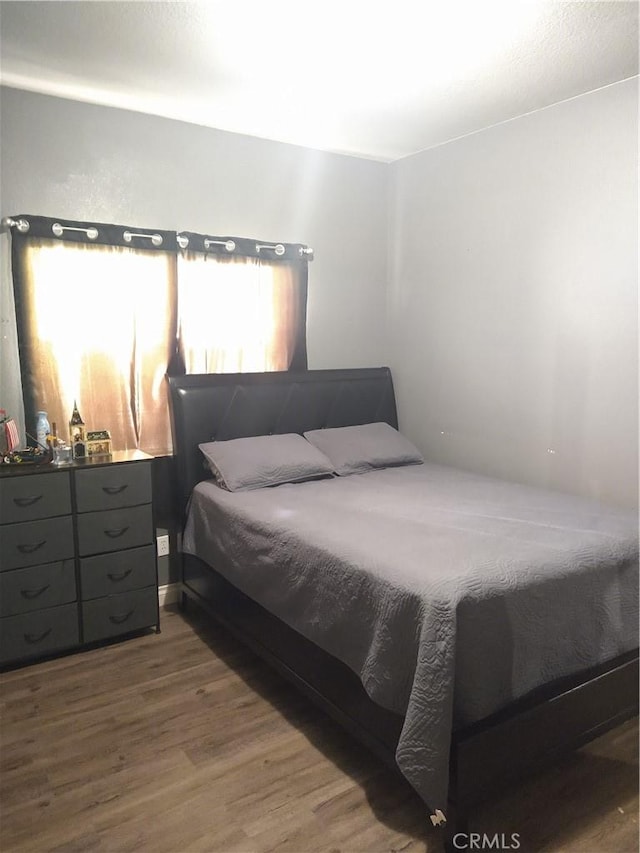 bedroom with wood-type flooring