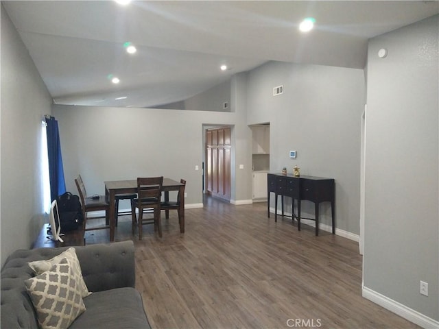 living room featuring lofted ceiling and dark wood-type flooring