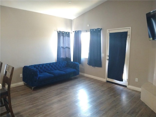 living room with dark hardwood / wood-style flooring and lofted ceiling