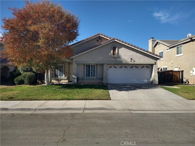 view of front facade featuring stucco siding, a front lawn, concrete driveway, a garage, and a tiled roof