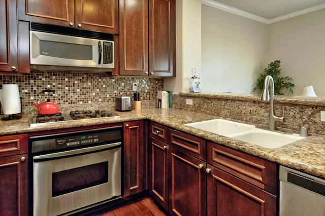 kitchen with crown molding, sink, stainless steel appliances, and light stone counters