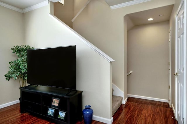 stairway with hardwood / wood-style floors and crown molding