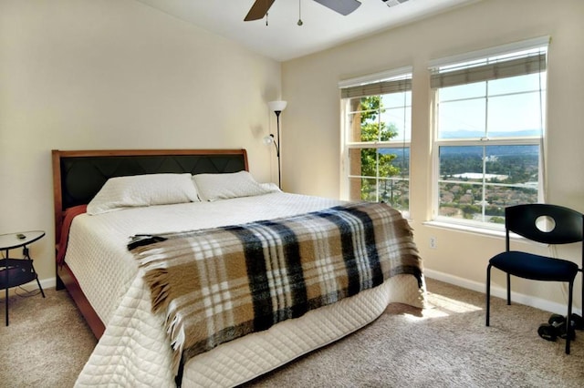 bedroom featuring carpet flooring, multiple windows, and ceiling fan