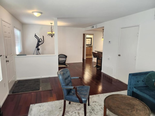 office space with an inviting chandelier and dark hardwood / wood-style floors