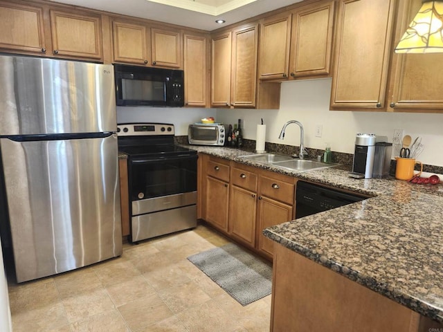 kitchen with dark stone countertops, sink, and black appliances