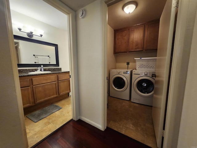 washroom with dark hardwood / wood-style flooring, sink, and washer and clothes dryer