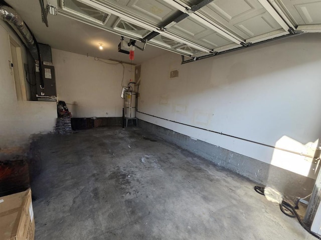 garage with strapped water heater and heating unit