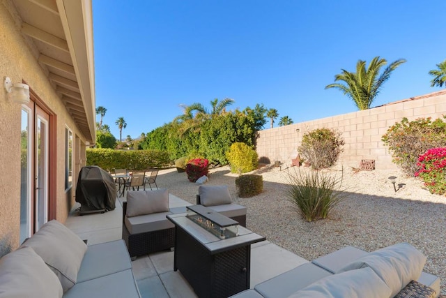 view of patio / terrace with grilling area and an outdoor living space with a fire pit