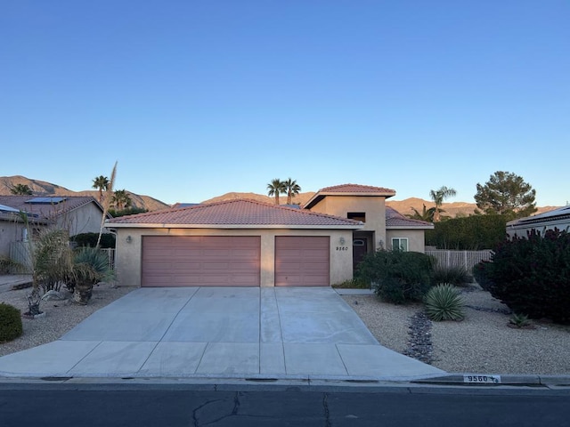 view of front of property featuring a mountain view and a garage