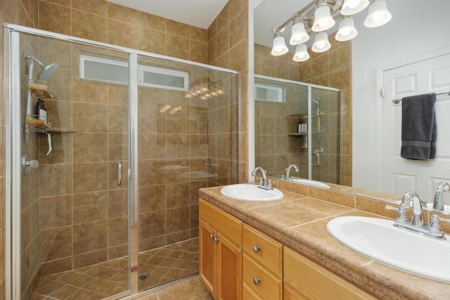 bathroom featuring tile patterned flooring, vanity, and an enclosed shower