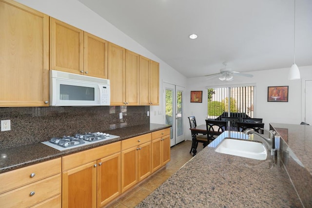 kitchen with white appliances, vaulted ceiling, ceiling fan, sink, and decorative light fixtures