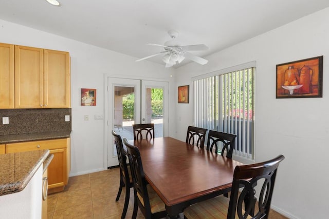 dining area with french doors, light tile patterned floors, and ceiling fan