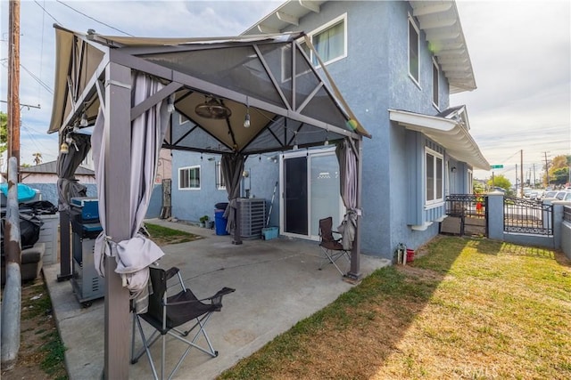 rear view of house with a patio, central AC unit, and a lawn