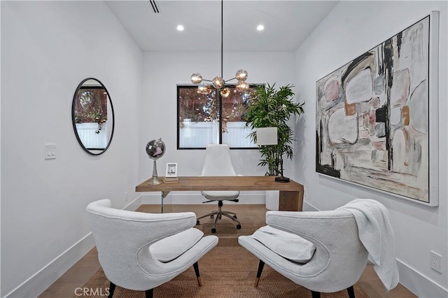 office space with wood-type flooring and a chandelier