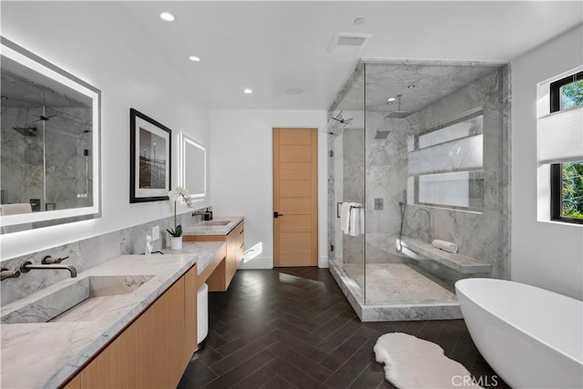 bathroom featuring vanity, parquet floors, and independent shower and bath